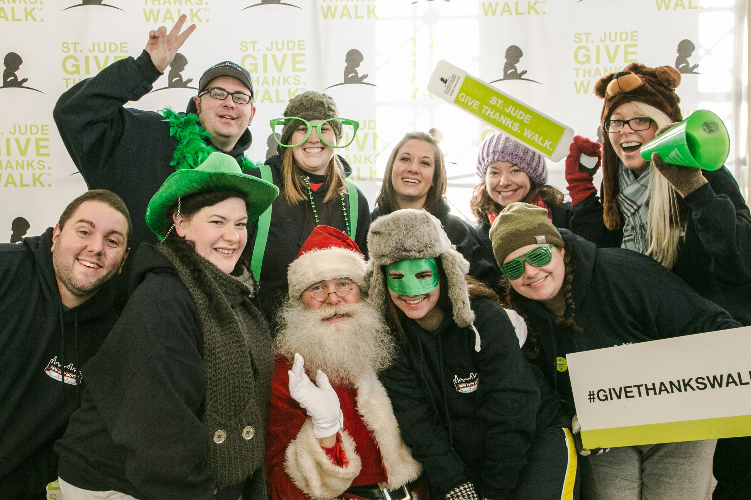 New City Moving employees pose with santa clause at st jude event.