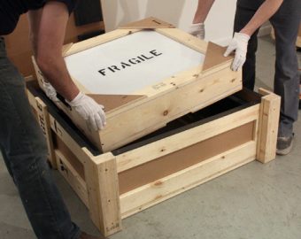 new city moving employees handling fragile boxes
