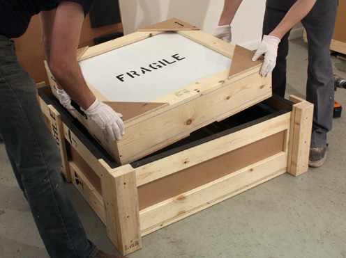 new city moving employees handling fragile boxes