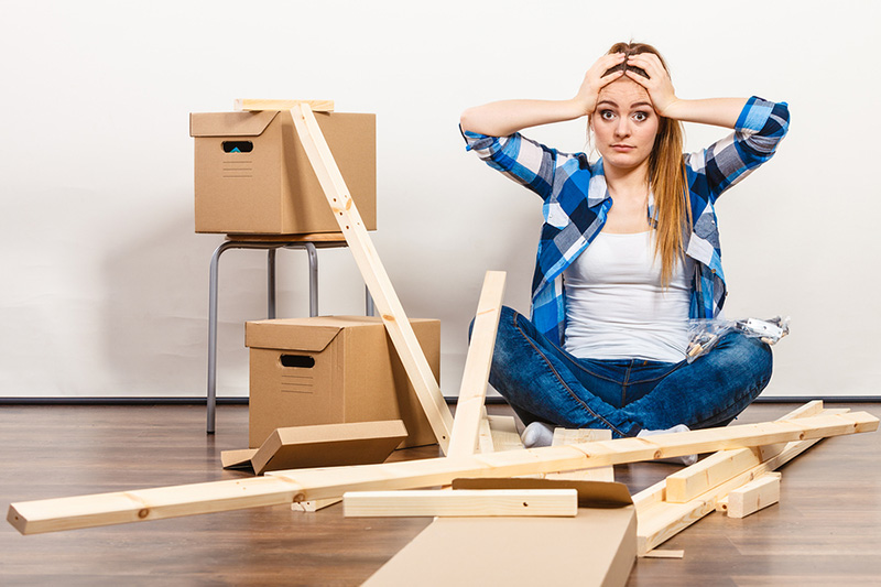 stressed customer trying to put furniture together