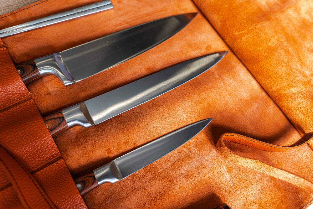 A set of knives in a leather case.
